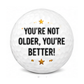 Golf ball with 'You're not older, you're better!' text on a white background
