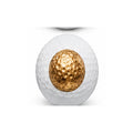 Golf ball with gold center on a white background